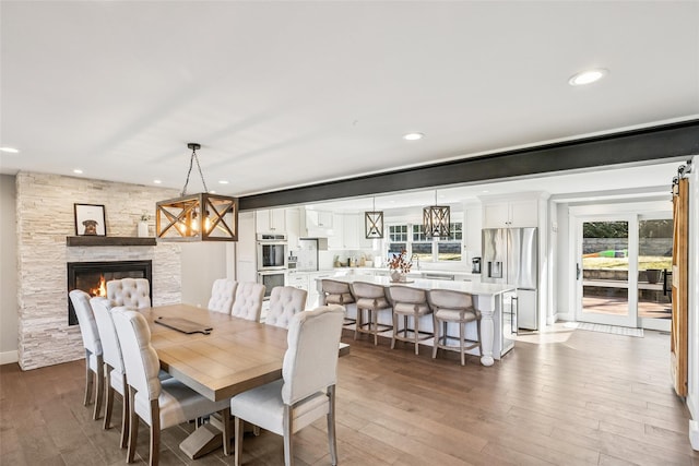 dining room featuring plenty of natural light, a chandelier, and hardwood / wood-style floors