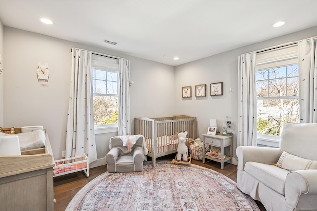 bedroom with multiple windows, wood finished floors, visible vents, and recessed lighting