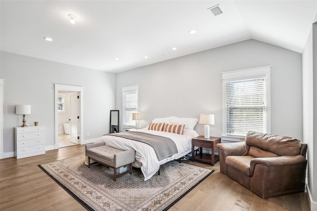 bedroom with lofted ceiling, light wood finished floors, baseboards, and recessed lighting