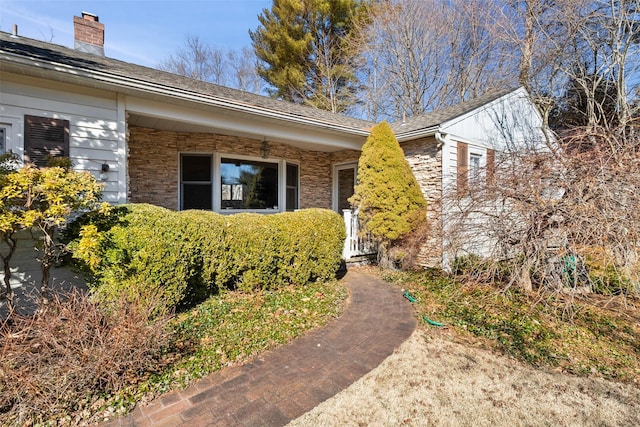 property entrance with a chimney