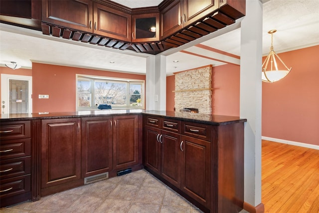 bar with pendant lighting, light tile patterned flooring, visible vents, and baseboards