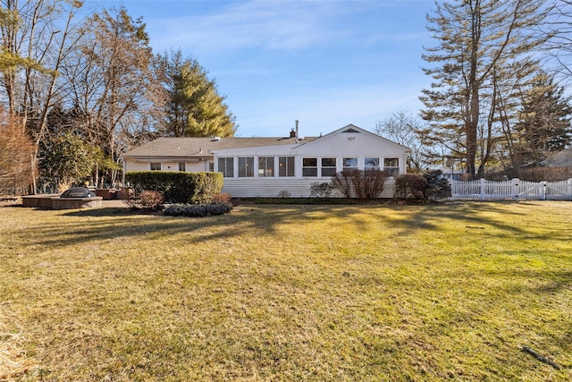 back of house with a yard and fence