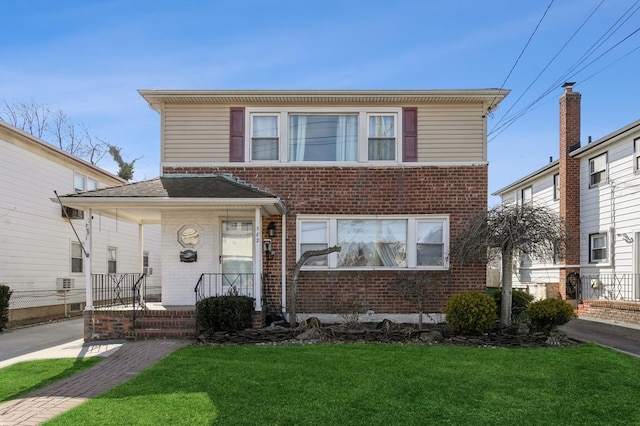 view of front of house with brick siding and a front yard