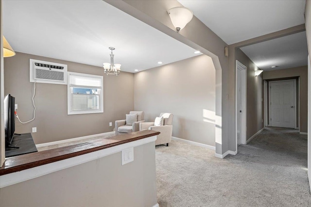 unfurnished living room featuring carpet, recessed lighting, an inviting chandelier, a wall mounted air conditioner, and baseboards