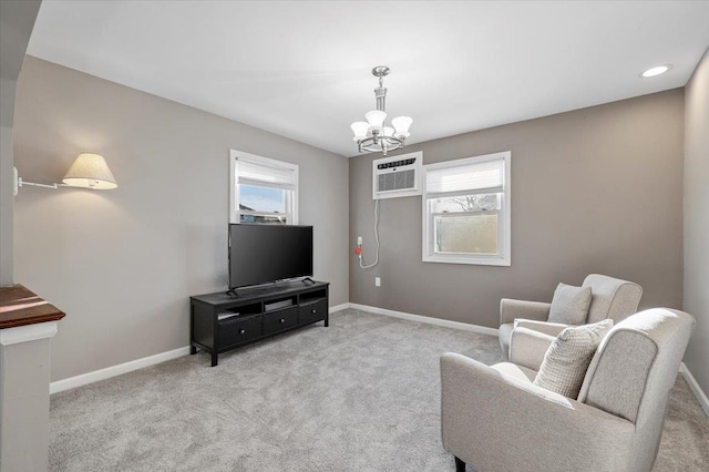 living area with a chandelier, an AC wall unit, carpet flooring, and baseboards