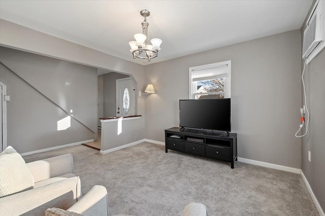 living area with carpet, a healthy amount of sunlight, arched walkways, and baseboards