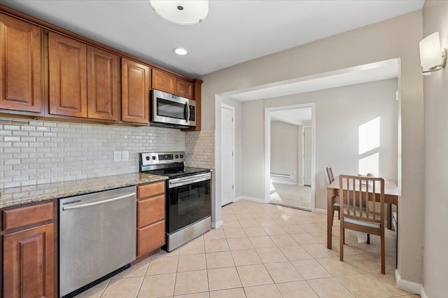 kitchen featuring brown cabinets, tasteful backsplash, and stainless steel appliances