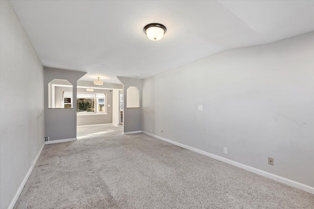 unfurnished room with carpet and baseboards