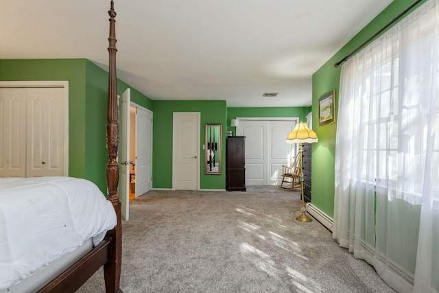 bedroom featuring multiple windows, carpet flooring, visible vents, and baseboards