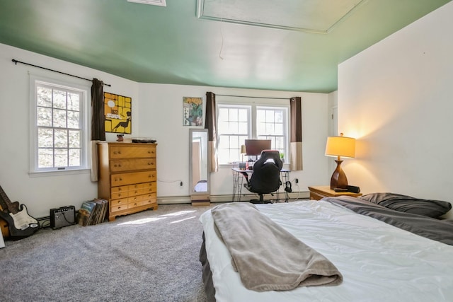 bedroom with attic access, multiple windows, and carpet flooring