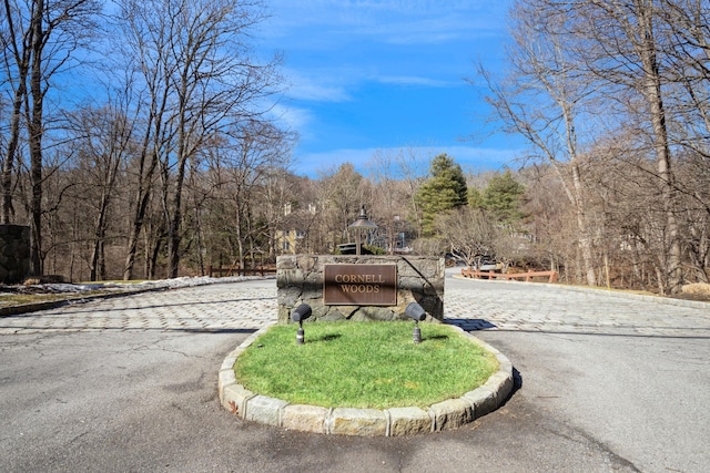 view of street featuring curbs and a forest view