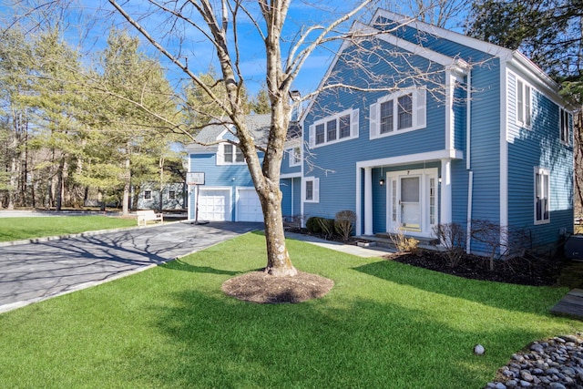 view of front of property with an attached garage, driveway, and a front yard