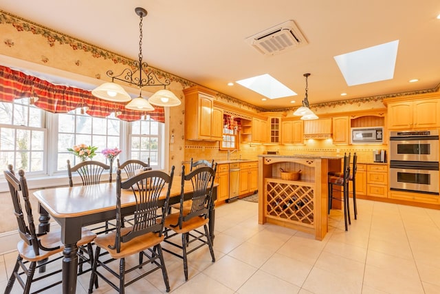 dining space with light tile patterned floors, a skylight, visible vents, and recessed lighting