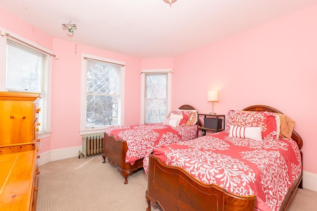 bedroom with radiator, baseboards, and carpet floors