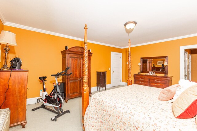 bedroom featuring baseboards, ornamental molding, and light colored carpet