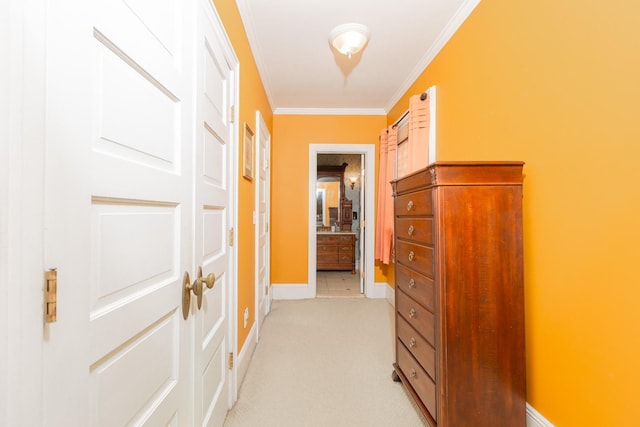 corridor with baseboards, light colored carpet, and crown molding