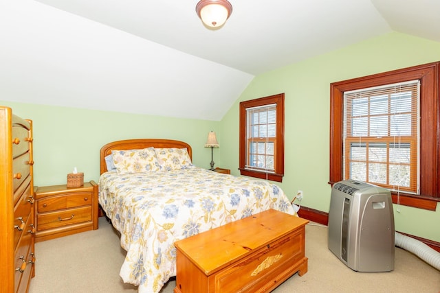 carpeted bedroom featuring multiple windows, baseboards, and vaulted ceiling