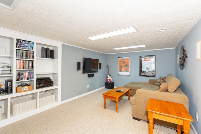 carpeted living room with ornamental molding and baseboards