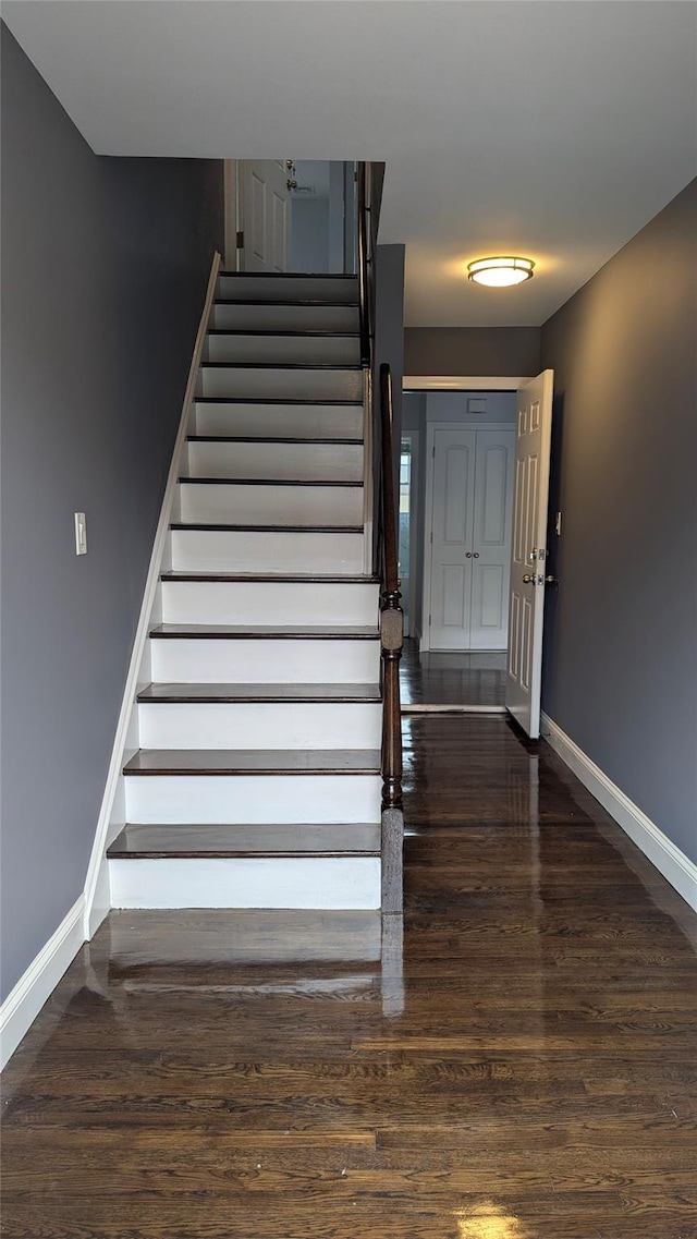 stairway featuring wood finished floors and baseboards