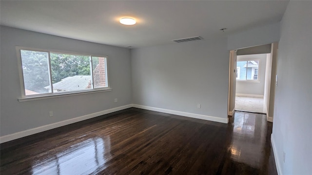 spare room featuring visible vents, plenty of natural light, and baseboards