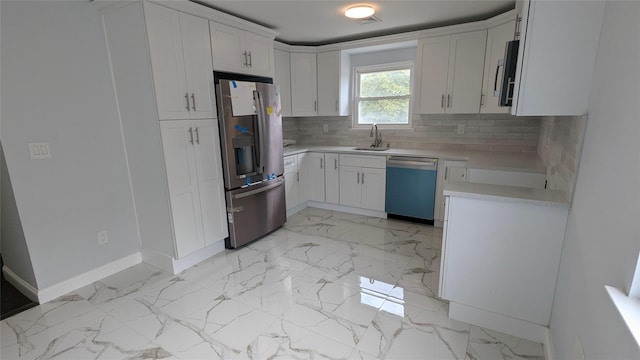 kitchen featuring stainless steel appliances, a sink, white cabinetry, marble finish floor, and light countertops