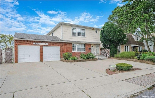 view of front of home featuring driveway, brick siding, and an attached garage