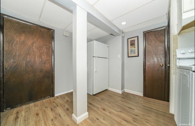 interior space with light wood finished floors and baseboards