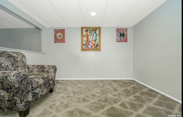 sitting room featuring carpet floors and baseboards