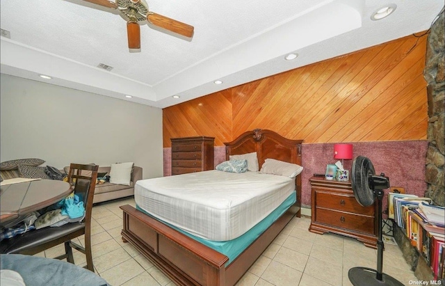 bedroom featuring light tile patterned floors, recessed lighting, a ceiling fan, and wooden walls