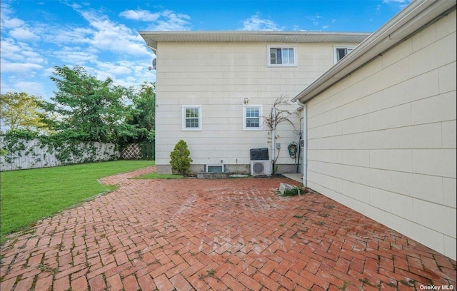 back of property featuring ac unit, a patio area, fence, and a lawn