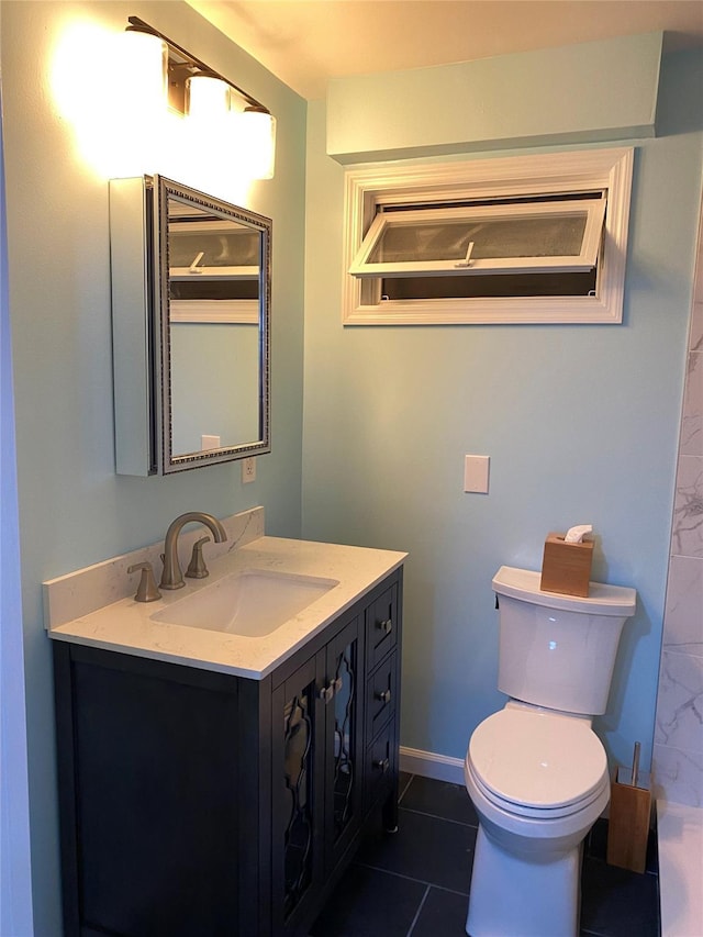 bathroom with toilet, baseboards, vanity, and tile patterned floors