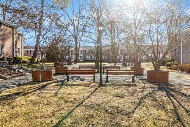 view of community with a residential view and a yard