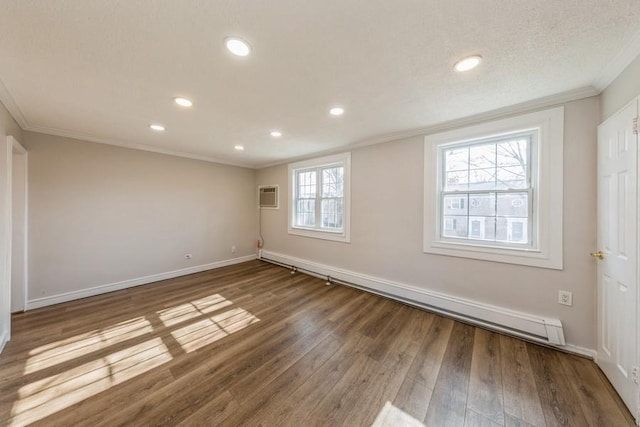 unfurnished room featuring baseboards, ornamental molding, wood finished floors, an AC wall unit, and recessed lighting