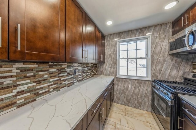 kitchen with tasteful backsplash, light stone counters, marble finish floor, stainless steel appliances, and recessed lighting