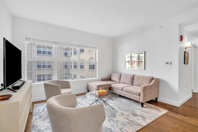 living room featuring wood finished floors and baseboards