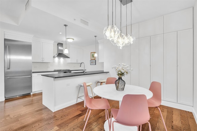 dining space featuring visible vents and light wood finished floors