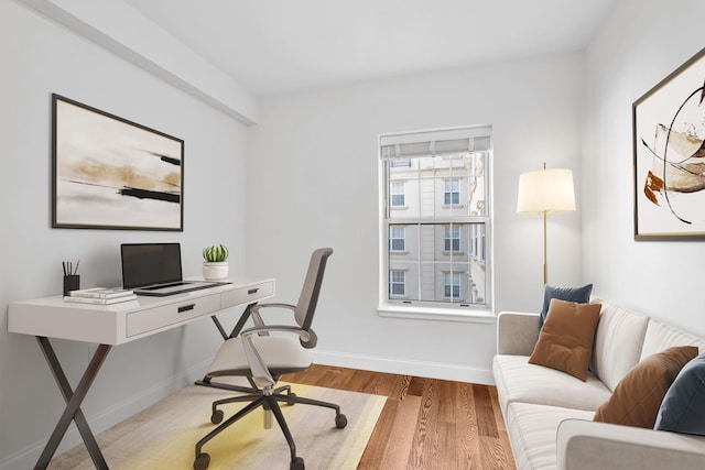 office featuring baseboards and wood finished floors