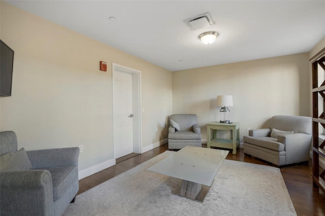 sitting room featuring dark wood finished floors, visible vents, and baseboards