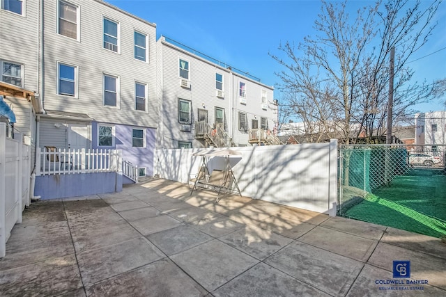 view of patio / terrace featuring a residential view and fence