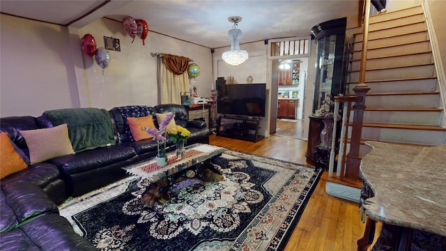 living area with stairway and wood finished floors