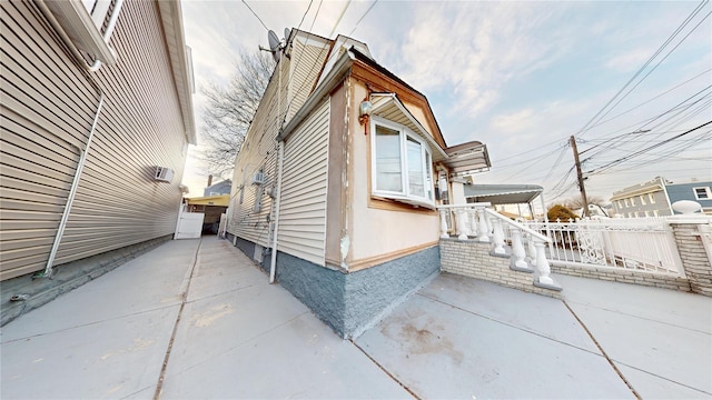 view of side of property with a patio area and fence