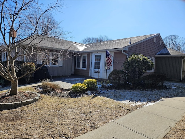 single story home with roof with shingles and a patio