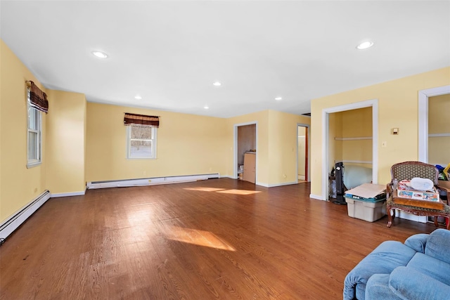 living room featuring a baseboard radiator, baseboards, dark wood-type flooring, and recessed lighting