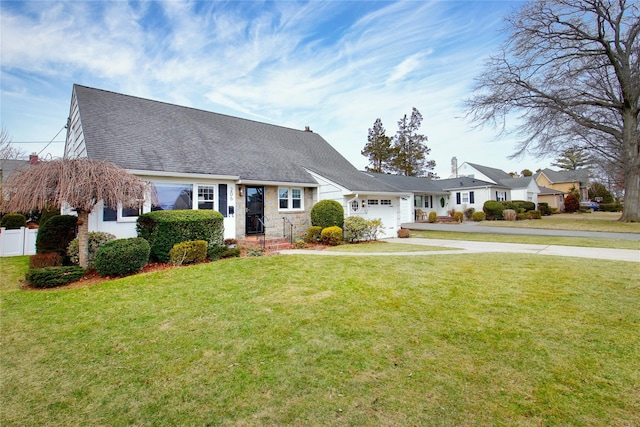 cape cod house featuring a garage, driveway, roof with shingles, and a front yard