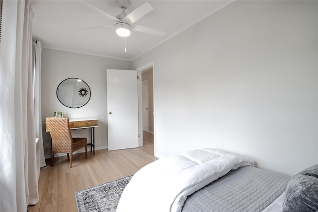 bedroom with light wood-type flooring, ornamental molding, and a ceiling fan