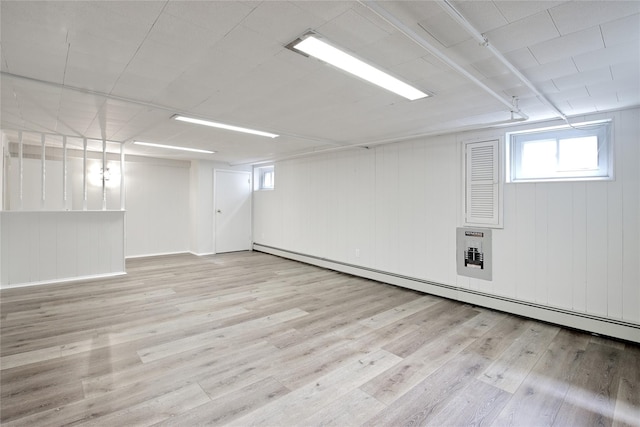 basement featuring baseboard heating and wood finished floors