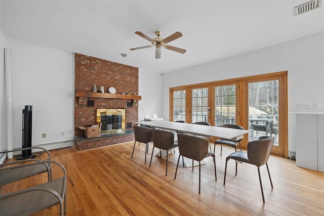 97 Ludlam Rd, Monroe, NY 10950 - dining area featuring ceiling fan, light wood-style flooring, and a fireplace