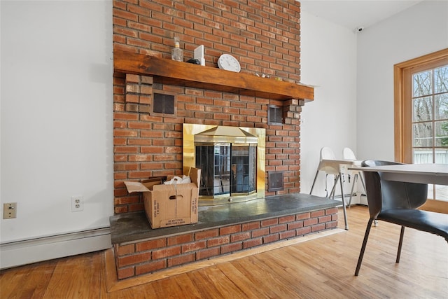 97 Ludlam Rd, Monroe, NY 10950 - detailed view of a baseboard radiator, wood finished floors, a fireplace, and a security system