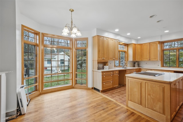 97 Ludlam Rd, Monroe, NY 10950 - kitchen with a sink, light countertops, a chandelier, black electric stovetop, and pendant lighting