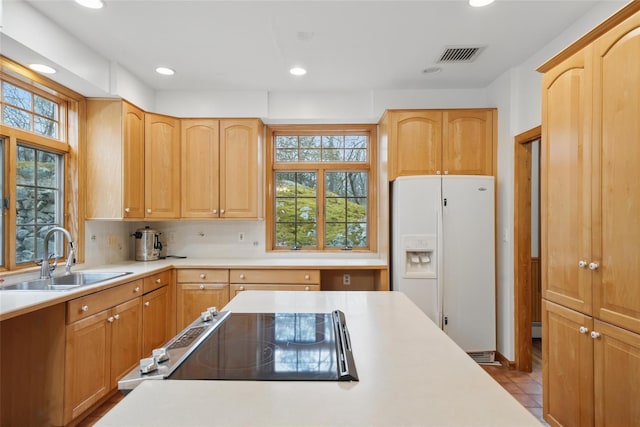 97 Ludlam Rd, Monroe, NY 10950 - kitchen featuring white refrigerator with ice dispenser, a sink, light countertops, recessed lighting, and backsplash